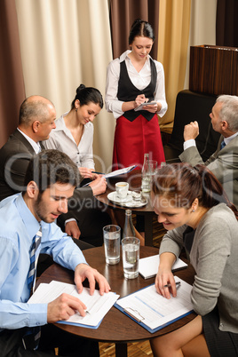 Waitress take order businesspeople conference room