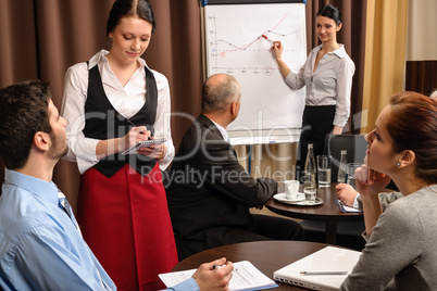 Waitress take order businesspeople conference room