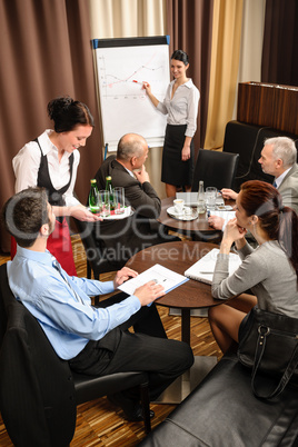 Waitress serving business people conference room