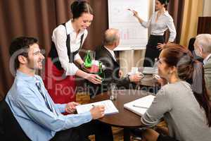 Waitress serving business people conference room