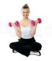 Young girl lifting weights