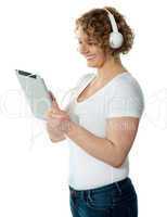 Woman listening to music on her i-pad