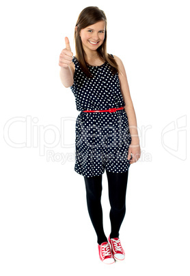 Glamorous teenager gesturing thumbs-up