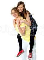 Teenage girl piggybacks her mother