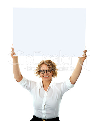Happy woman holding blank billboard
