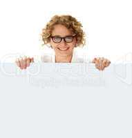 Female business professional holding blank billboard