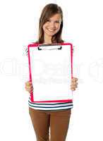 Teenager showing blank paper on clipboard