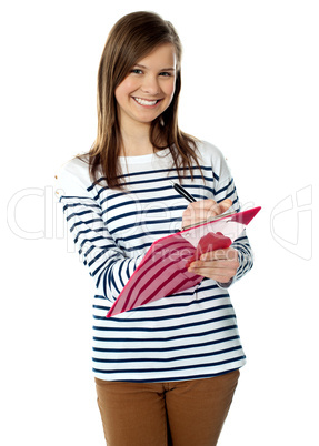 Portrait of young girl writing on documents