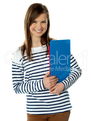 Smiling cute trendy girl holding documents and posing