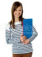 Smiling cute trendy girl holding documents and posing