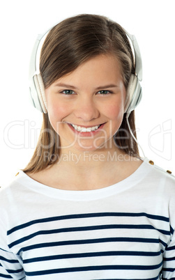 Closeup of a smiling beauty enjoying music