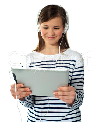 Pretty young girl enjoys listening music