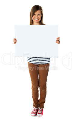 Smiling girl holding empty white board