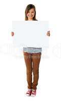 Smiling girl holding empty white board