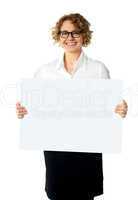 Caucasian businesswoman holding a blank billboard