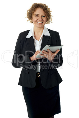 Curly haired corporate woman posing with ipad