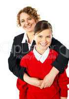 Teacher embracing her student from back