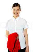 School girl holding her red sweater and smiling