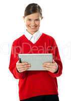 School girl holding tablet computer