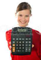 Smiling school girl showing digital calculator