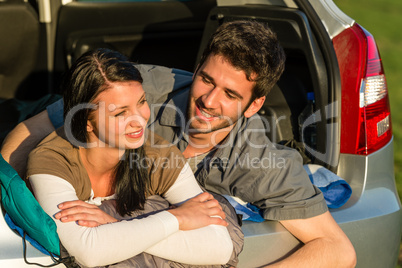 Camping young couple lying car summer sunset