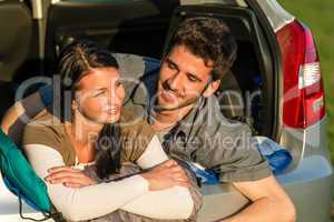Camping young couple lying car summer sunset