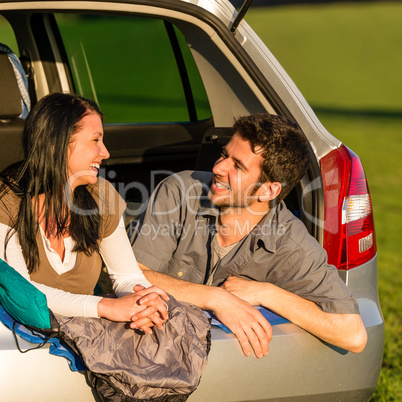 Camping young couple lying car summer sunset