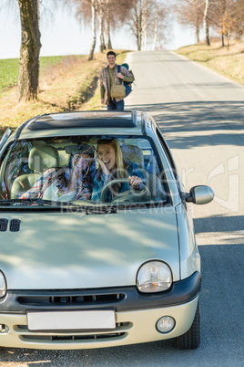 Exciting girls drive car taking hitch-hiker
