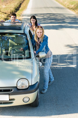 Pushing car technical failure young friends road