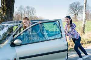 Pushing car technical failure two young women