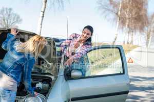 Starting broken car two women have problems