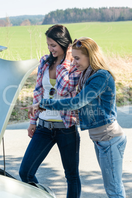 Car breakdown two women looking under hood