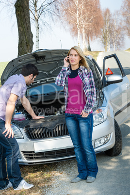 Car breakdown couple calling for road assistance