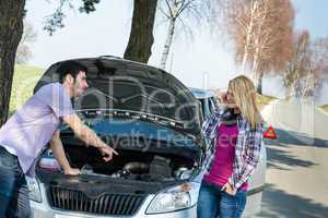 Car breakdown couple calling for road assistance