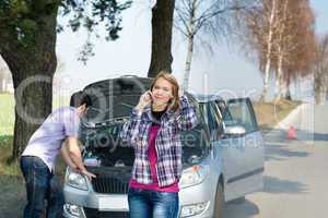 Car breakdown couple calling for road assistance