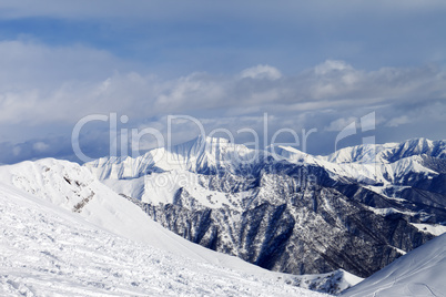 Ski slope and snowy mountains