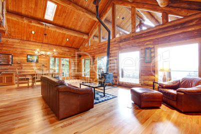 Luxury log cabin living room with leather sofa.