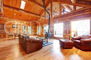 Luxury log cabin living room with leather sofa.