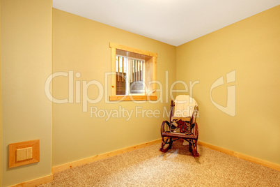 Simple empty basement bedroom with chair.