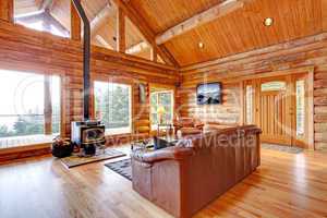 Luxury log cabin living room with leather sofa.