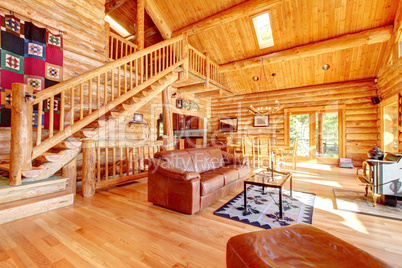 Luxury log cabin living room with leather sofa.