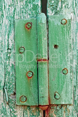 Old hinges on the wooden boards