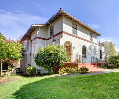 Spanish style white large home front exterior.