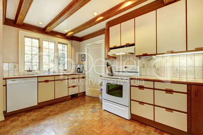 Old simple white and wood kitchen with hardwood floor.