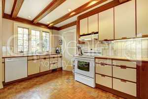 Old simple white and wood kitchen with hardwood floor.