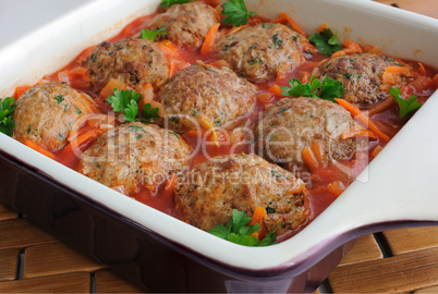 Meatballs with herbs and tomato sauce in the pan