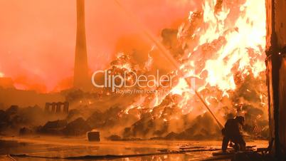 Fireman and large industrial fire