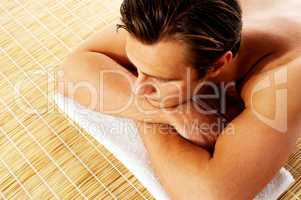 Man relaxing in a spa resort on mat
