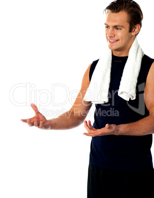Male trainer posing with open hands and looking away