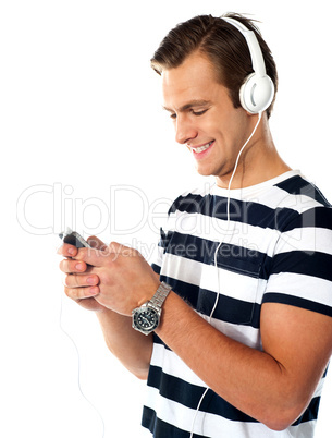 Male teenager with mp3 player and earbuds